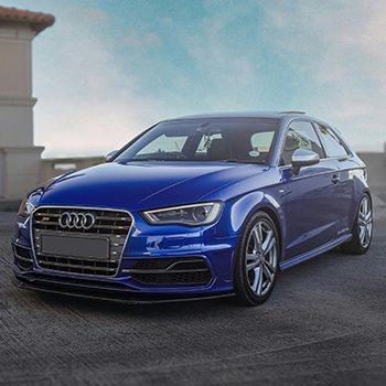 Blue Audi S3 parked outside on pavement